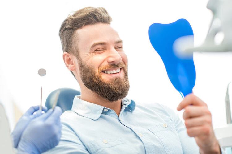 smiling at dentist beautiful dental crowns