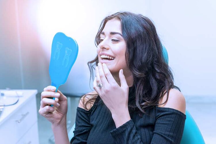 patient at dentist happy with beautiful smile