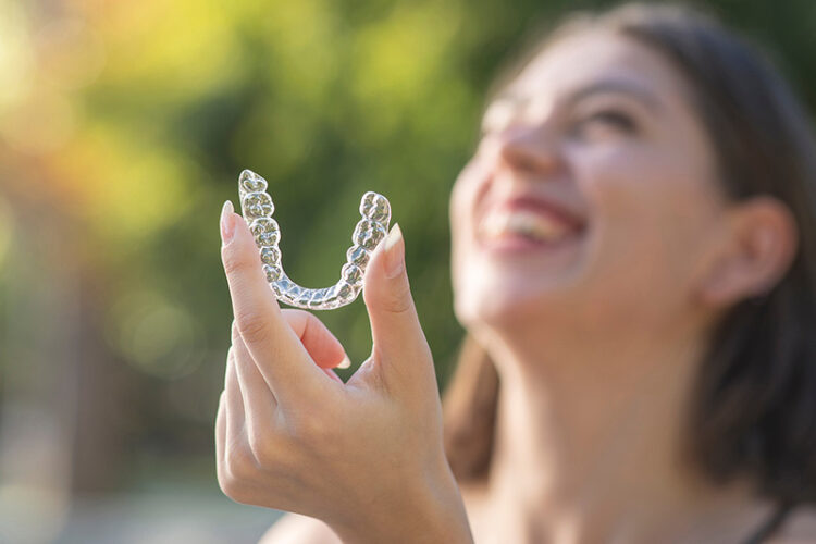 Clear aligner closeup representing Invisalign and clear aligner treatment options available at Deluxe Dental in Miami, Kendall, and Medley.